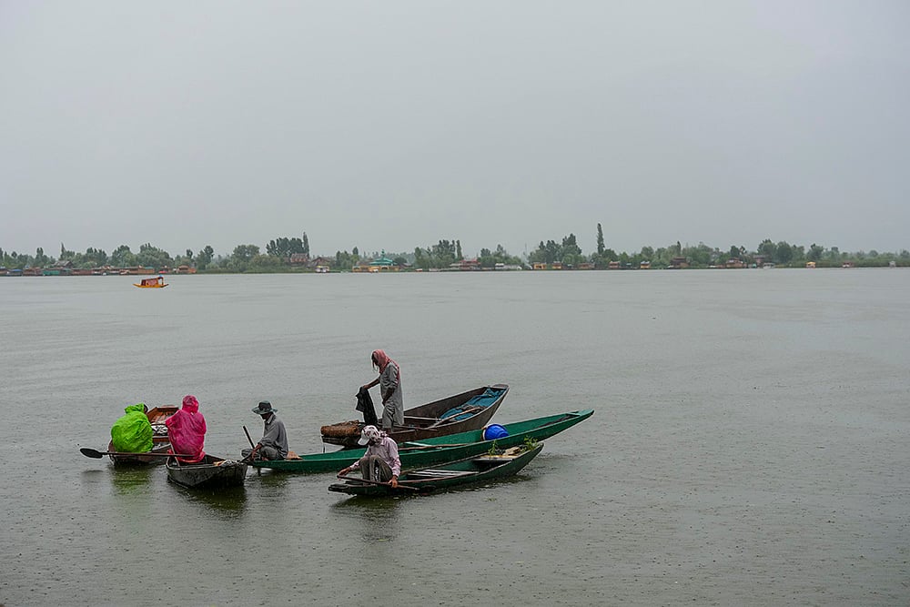 | Photo: PTI/S Irfan : Weather: Rain in Srinagar